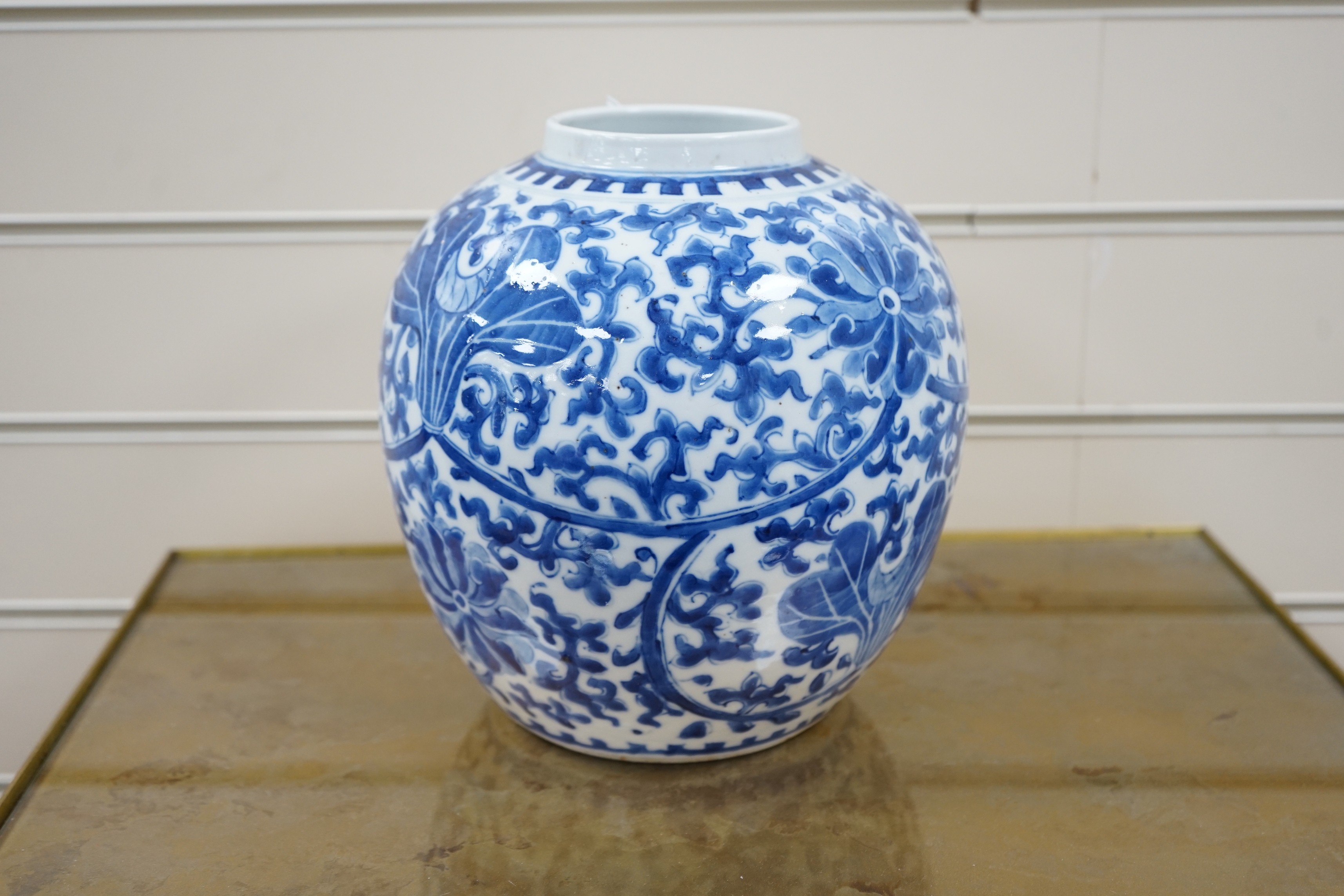 A late 19th century Chinese blue and white ovoid jar. 22cm tall, apocryphal Kangxi mark